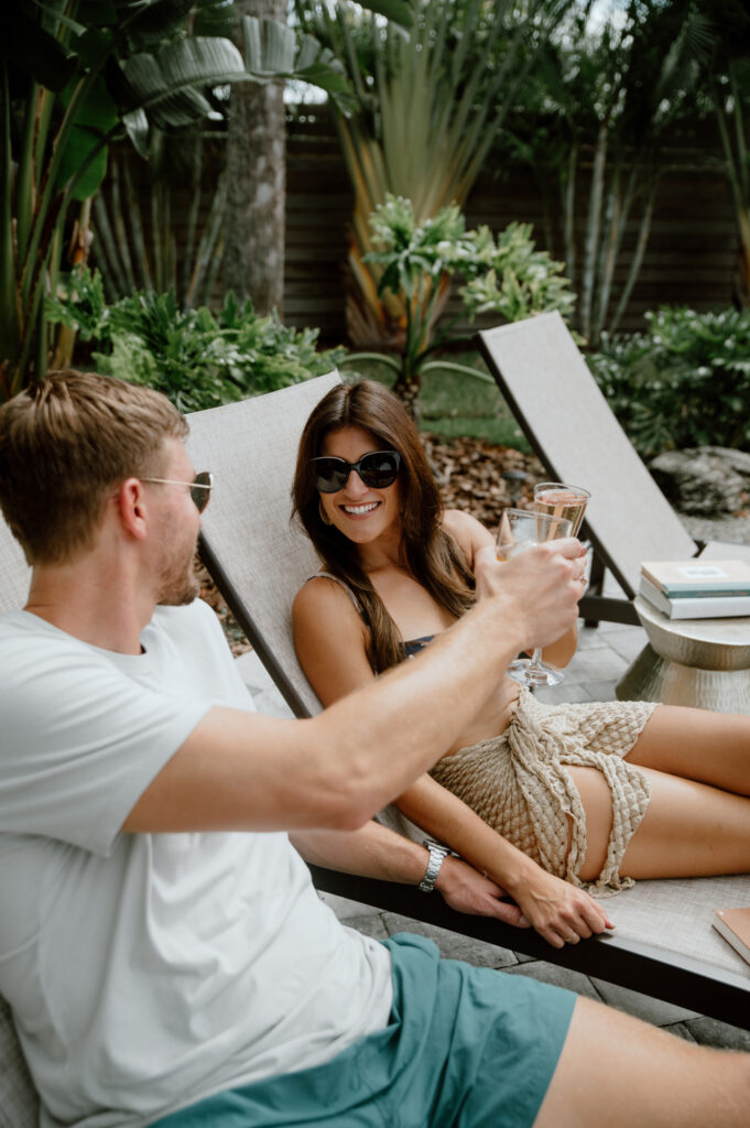 Couple doing a cheers by the pool in Cocoa Beach, Florida