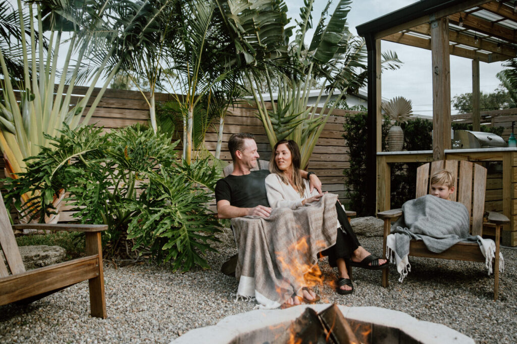 Couple sitting by fire in backyard of a Footprint by Lalonde property in Cocoa Beach, Florida