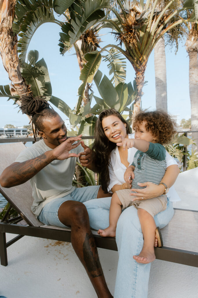 Family sitting together in sun chair on a Footprint by Lalonde property in Cocoa Beach, Florida.