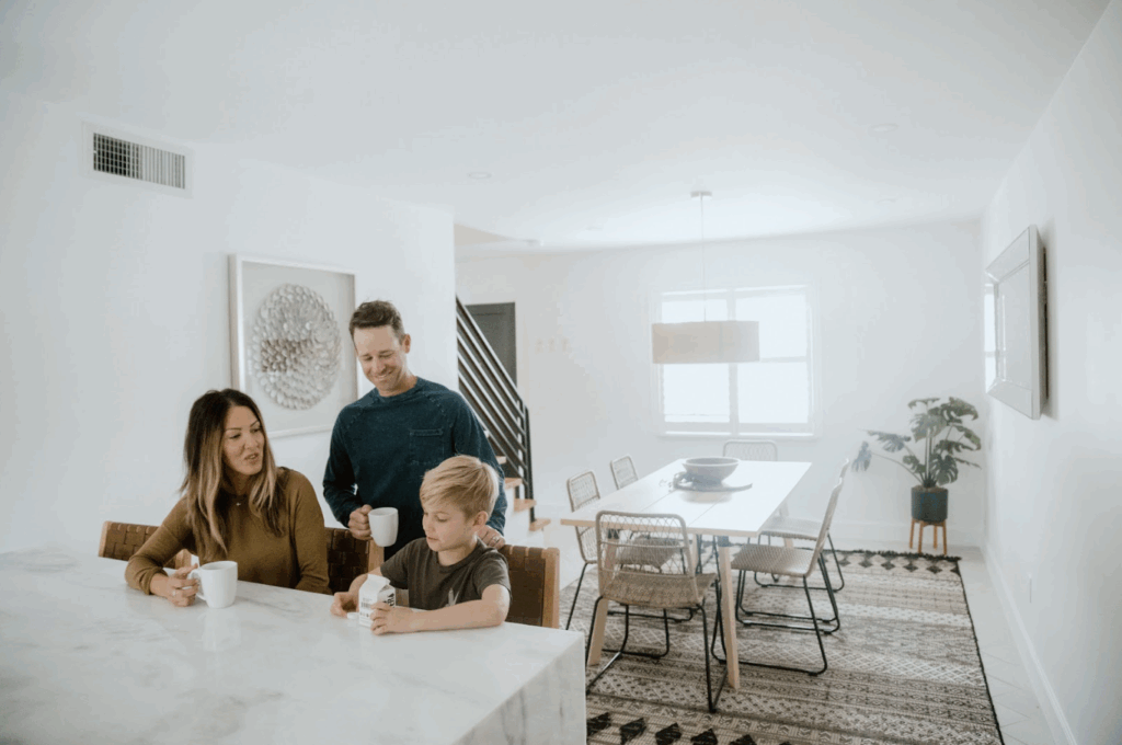 Family sitting at breakfast bar at one of the Footprint by Lalonde properties in Cocoa Beach, Florida