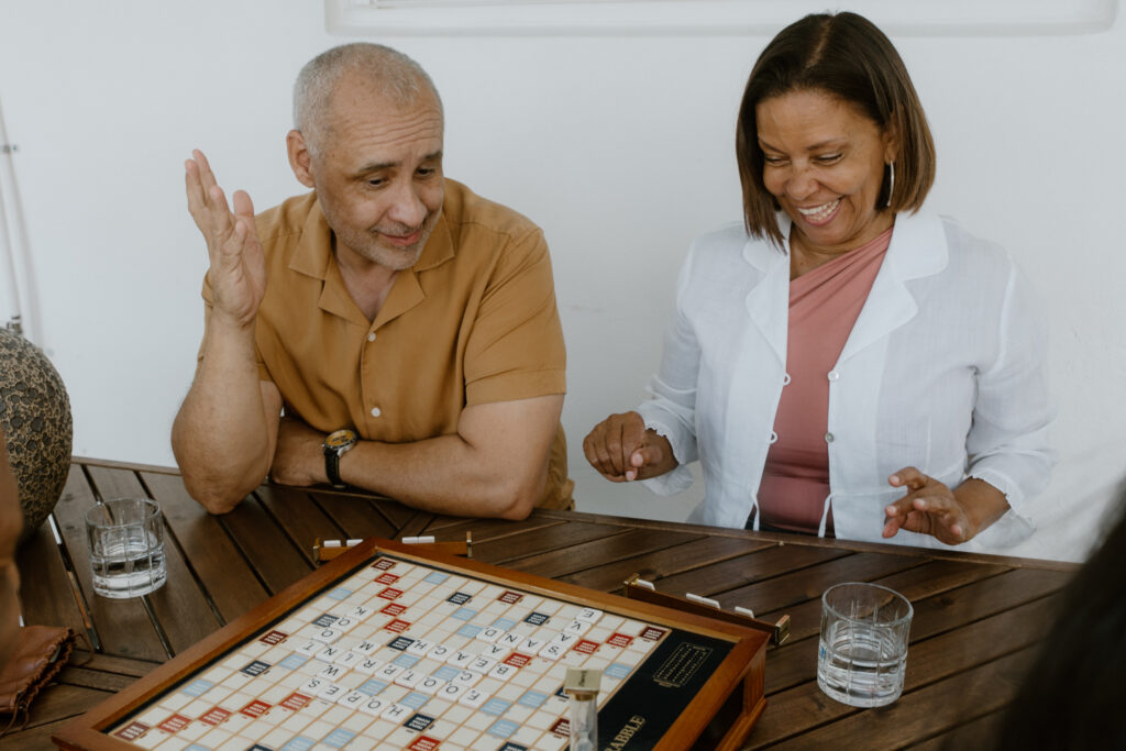 Guests enjoying a board game together at a boutique vacation home in Cocoa Beach.