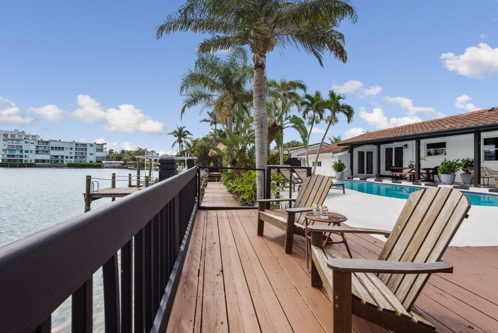 A teak deck with views of palm trees and blue skies in Cocoa Beach, Florida